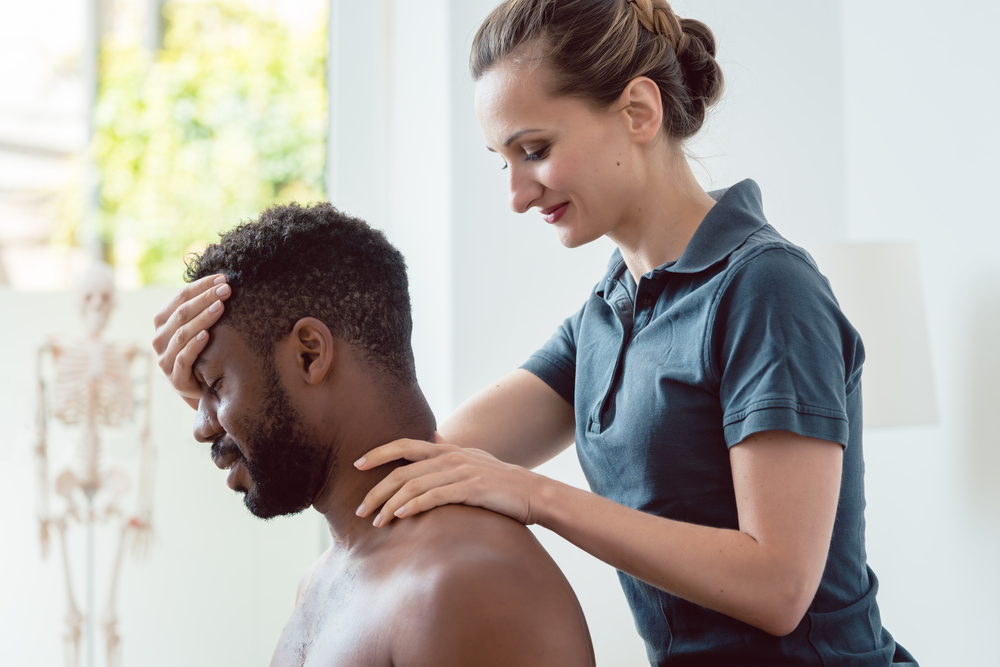 What Does Physical Therapy Treat? - Woman physical therapist massaging young man